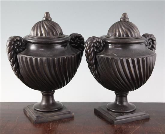 A pair of bronze urns and covers, 12in.